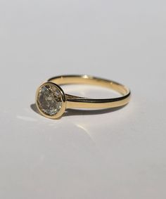 A Salt & Pepper Cognac diamond in a high bezel setting revealing the side profile of the ring. Specifications: Approx 1ct (1.18ct) round double cut salt and pepper diamond, in a high bezel setting, in 14k yellow Custom sized in approx. 10-14 days. Please contact us about rush orders. Timeless Round Single Diamond Wedding Ring, Everyday Classic Brilliant Cut Diamond Ring, Formal Diamond Ring With Rose Cut Round Stone, Classic Moissanite Ring With Bezel Setting, Formal Rose Cut Diamond Ring With Round Stone, Formal Rose Cut Diamond Ring, Timeless Everyday Diamond Ring With Round Cut, Timeless Diamond Ring With Bezel Setting, Everyday Timeless Round Cut Diamond Ring