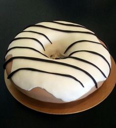 a frosted donut sitting on top of a wooden plate covered in icing