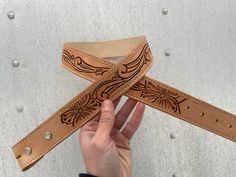 "Gorgeous fully tooled belt for sale! With a simple flower scroll design and made from durable Herman oak leather this belt will last you a lifetime! Smooth Herman oak liner to make for a soft interior.  This belt is 39\" long total. A 34\" hole is the middle hole!  Please check your own belt that fits you before ordering!! There are no returns for sizing yourself wrong.  If your a size 26-29 in women's ariat jeans this will fit you well!" Leather Belt Designs, Tooled Belt, Ariat Jeans, Tool Belt, Simple Flower, Scroll Design, Simple Flowers, Suspender Belt, Mini Wallet