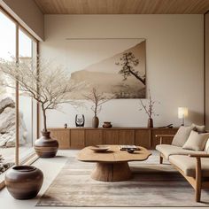 a living room filled with furniture next to a painting on the wall and two vases