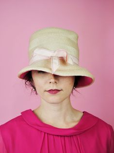 This hat would be perfect for a summer wedding or derby! Such a cute accessory. The straw like exterior is really elevated with the pink under the brim - the perfect pop of color! Tag says "Fashion Guild". FREE SHIPPING Measurements: Circumference for head: 21 inches Height: about 5 inches Good vintage condition - The ribbon is ever so slightly frayed at the edges with a few minor spots on the straw. See photos. Minor bends from prior storage to the piece, but sets well on the head. Please note: Pink Sun Hat With Curved Brim For Summer, Pink Straw Hat For Summer, Pink Curved Brim Sun Hat For Summer, Pink Straw Sun Hat For Summer, Chic Spring Boater Hat For Garden Party, Chic Cloche Sun Hat For Summer, Chic Summer Cloche Sun Hat, Summer Pink Boater Hat With Curved Brim, Chic Cloche Straw Hat For Summer