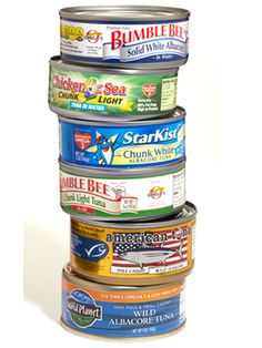 a stack of canned food items sitting on top of each other in front of a white background