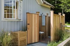 an outdoor shower in front of a house