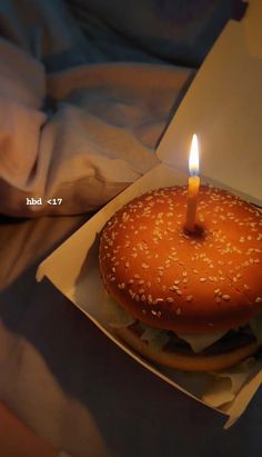 a hamburger with a lit candle in it