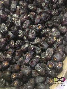 some black olives are in a bowl on the table and ready to be eaten