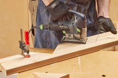 a man using a power tool on a piece of wood