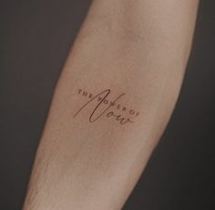 a person with a tattoo on their arm that says the power of love written in cursive writing