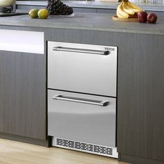 a stainless steel dishwasher sitting on top of a kitchen counter next to fruit