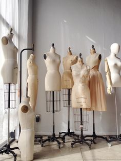 several mannequins are lined up in front of a window