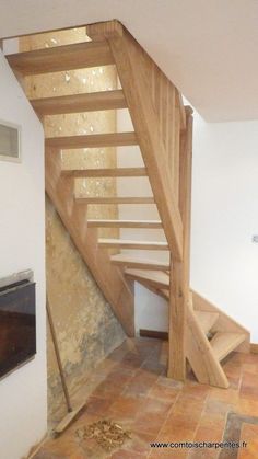 a wooden stair case in an unfinished room