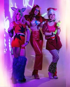 three women dressed up in costumes posing for the camera