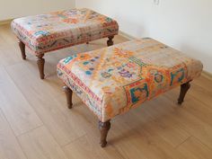 two foot stools sitting on top of a hard wood floor