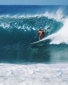 a man riding a wave on top of a surfboard