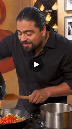 a man cooking food on top of a stove in front of a pot and pan