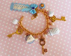 a close up of a bracelet on a table with keys and other items attached to it