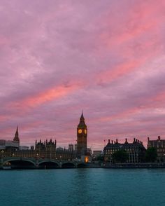 the big ben clock tower towering over the city of london, england at sunset or dawn