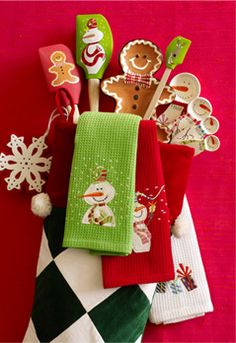 christmas themed kitchen towels and utensils are on display