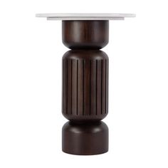 a brown and white table sitting on top of a wooden pedestal