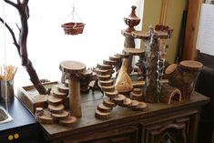 a wooden table topped with lots of different types of wood pieces and tree stumps