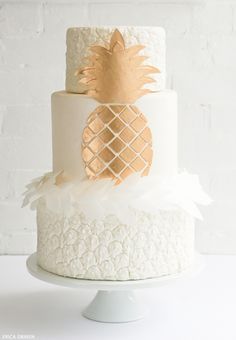 a white and gold pineapple wedding cake