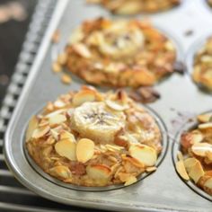 muffins with banana slices and nuts in a metal tray on top of an oven rack