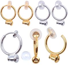 four pairs of gold, silver and white nose rings with screws on each end