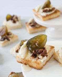 small appetizers with pickles and cream cheese on them