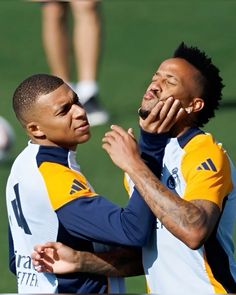 two soccer players are congratulating each other