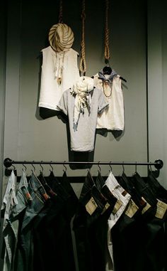 some clothes hanging up on a rack in a room