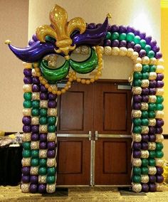 a mardi gras entrance decorated with balloons