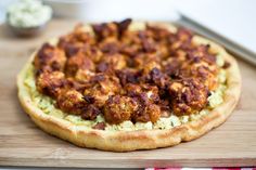 a pizza sitting on top of a wooden cutting board