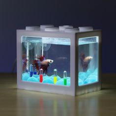 there is a lego fish in the box on the table with it's lights on