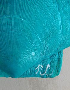 a close up view of the inside of a turquoise colored object with writing on it