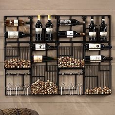 a wine rack filled with bottles and glasses next to a wall mounted wine glass holder