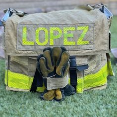 an open firefighter's bag sitting on the grass