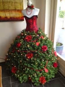 a mannequin is dressed up in a dress made out of christmas tree branches