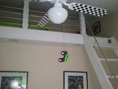 a white ceiling fan mounted to the side of a staircase