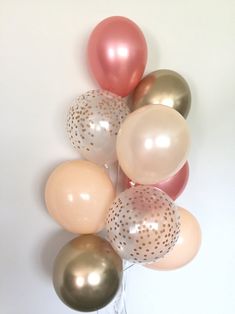 a bunch of balloons that are in the shape of polka dots on a white background