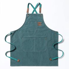 a green apron with two straps hanging from it's front and side pockets, on a white background