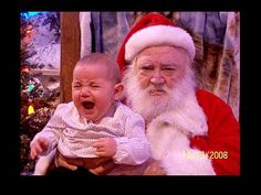 a baby crying while sitting next to santa clause