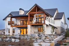 a large white house with lots of windows and stone steps leading up to the front door