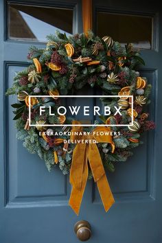 a blue door with a yellow ribbon hanging from it's side and the words flowerbox on top