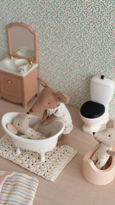 there is a toy bathtub with stuffed animals in it