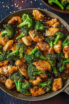 chicken and broccoli stir fry in a skillet with sesame seeds on the side