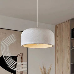 a white lamp hanging from the ceiling in a living room