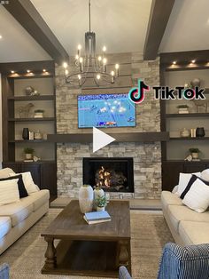 a living room filled with furniture and a flat screen tv mounted on the wall above a fireplace