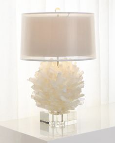 a white lamp sitting on top of a table