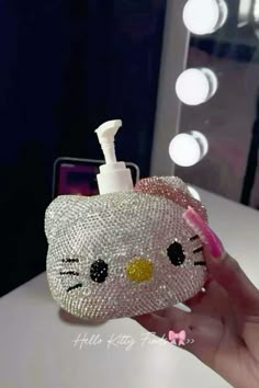 a hello kitty hand soap dispenser is shown in front of a mirror