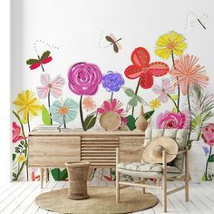 a living room with flowers painted on the wall and a chair in front of it