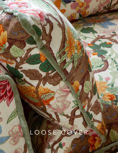 close up of the back of a floral patterned couch with green ribbon on it's end